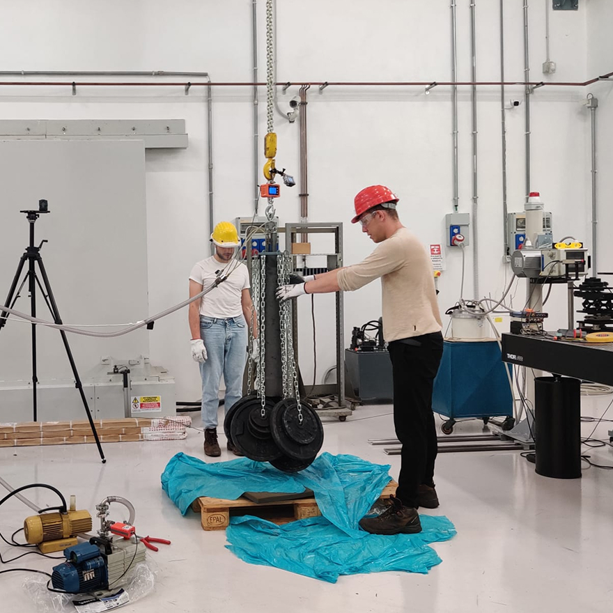 GraphiCore team testing a robotic lifting system in the laboratory